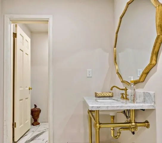 a room with a mirror and a sink