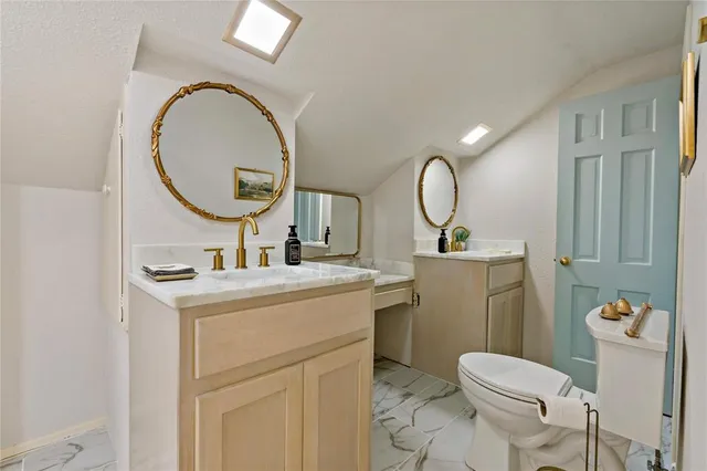 a bathroom with a toilet sink and mirror