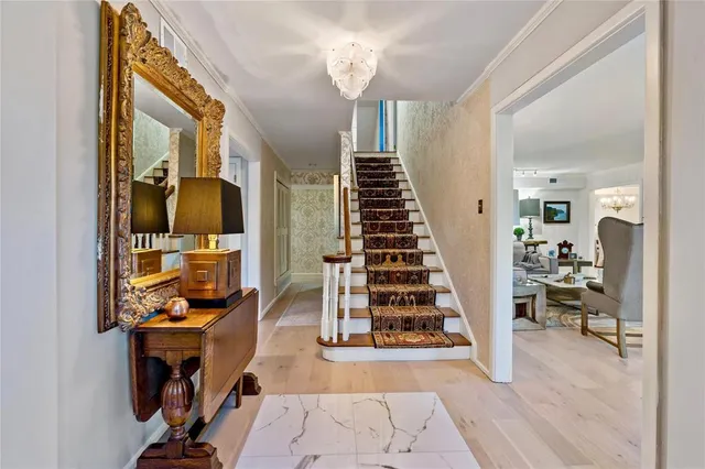 a view of a livingroom with wooden floor and furniture