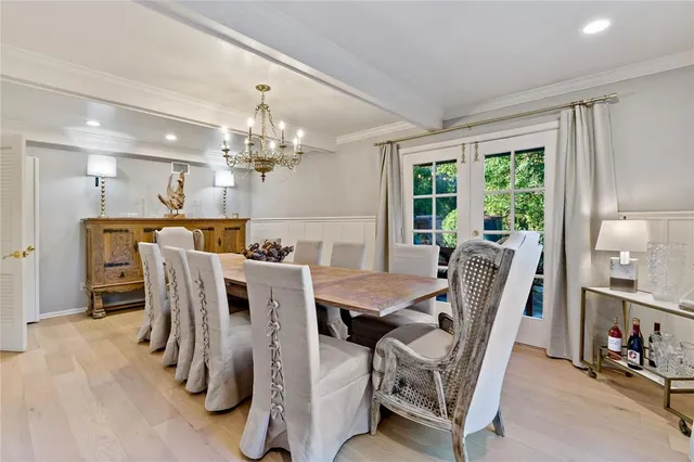 a view of a dining room with furniture and a chandelier