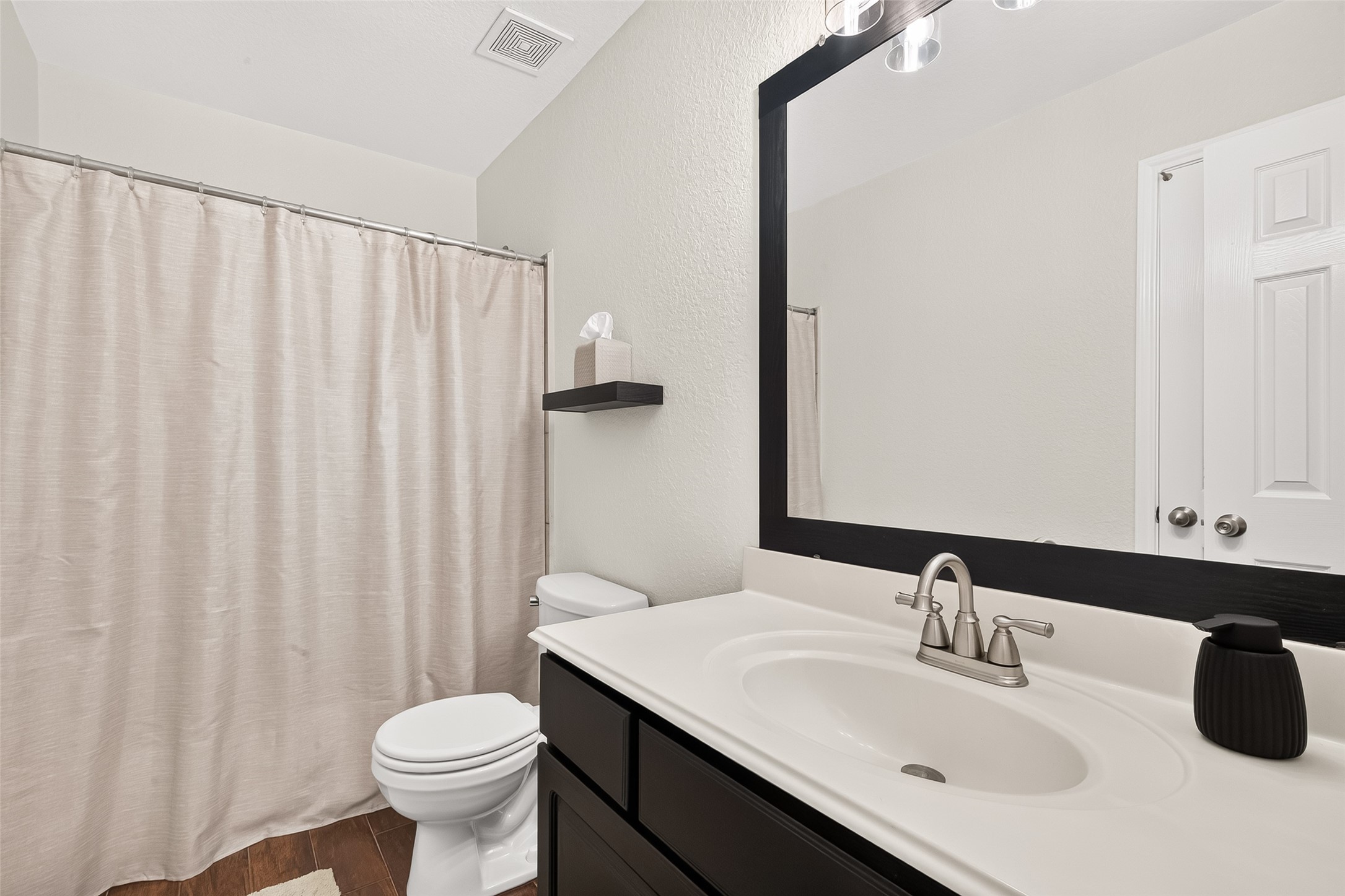 3155 View Valley Trail Katy, TX 77493 - Photo 39 of 50 Stylish secondary bathroom complete with a modern dark vanity mirror and a clean tub-shower combo