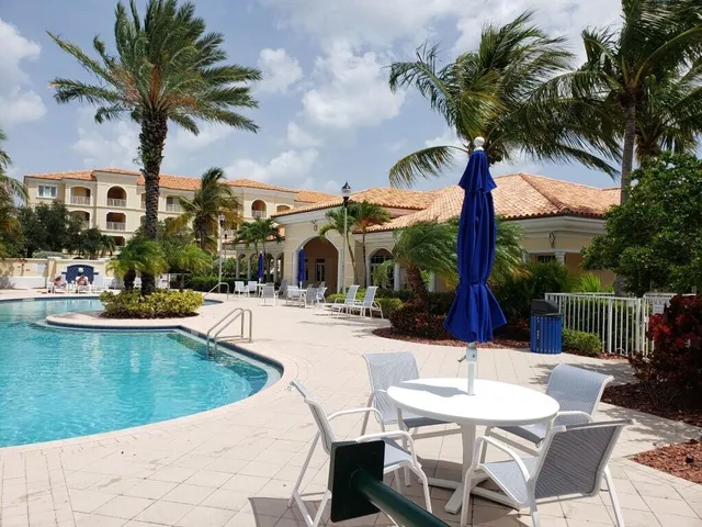 a view of a patio with swimming pool table and chairs