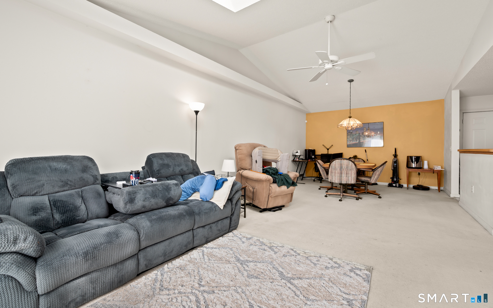 117 Dibble Hollow Lane, Unit 117 Windsor Locks, CT 06096 - Photo 12 of 34 a living room with furniture and a chandelier