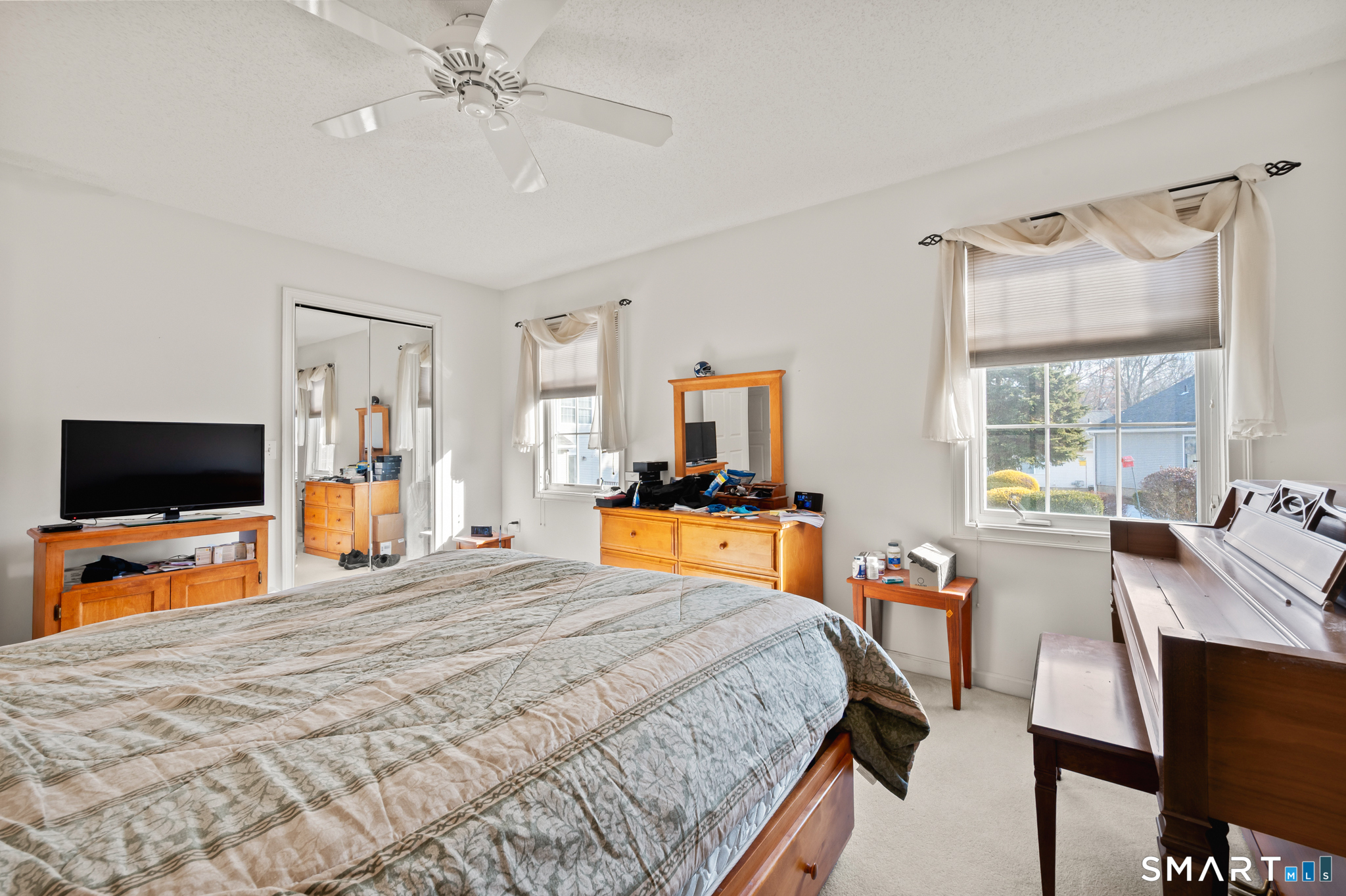 117 Dibble Hollow Lane, Unit 117 Windsor Locks, CT 06096 - Photo 17 of 34 a bedroom with a bed and a flat tv screen on dresser