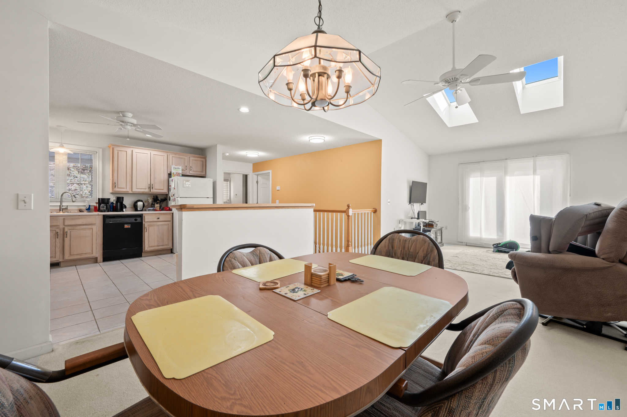 117 Dibble Hollow Lane, Unit 117 Windsor Locks, CT 06096 - Photo 7 of 34 a view of a dining room with furniture and a chandelier