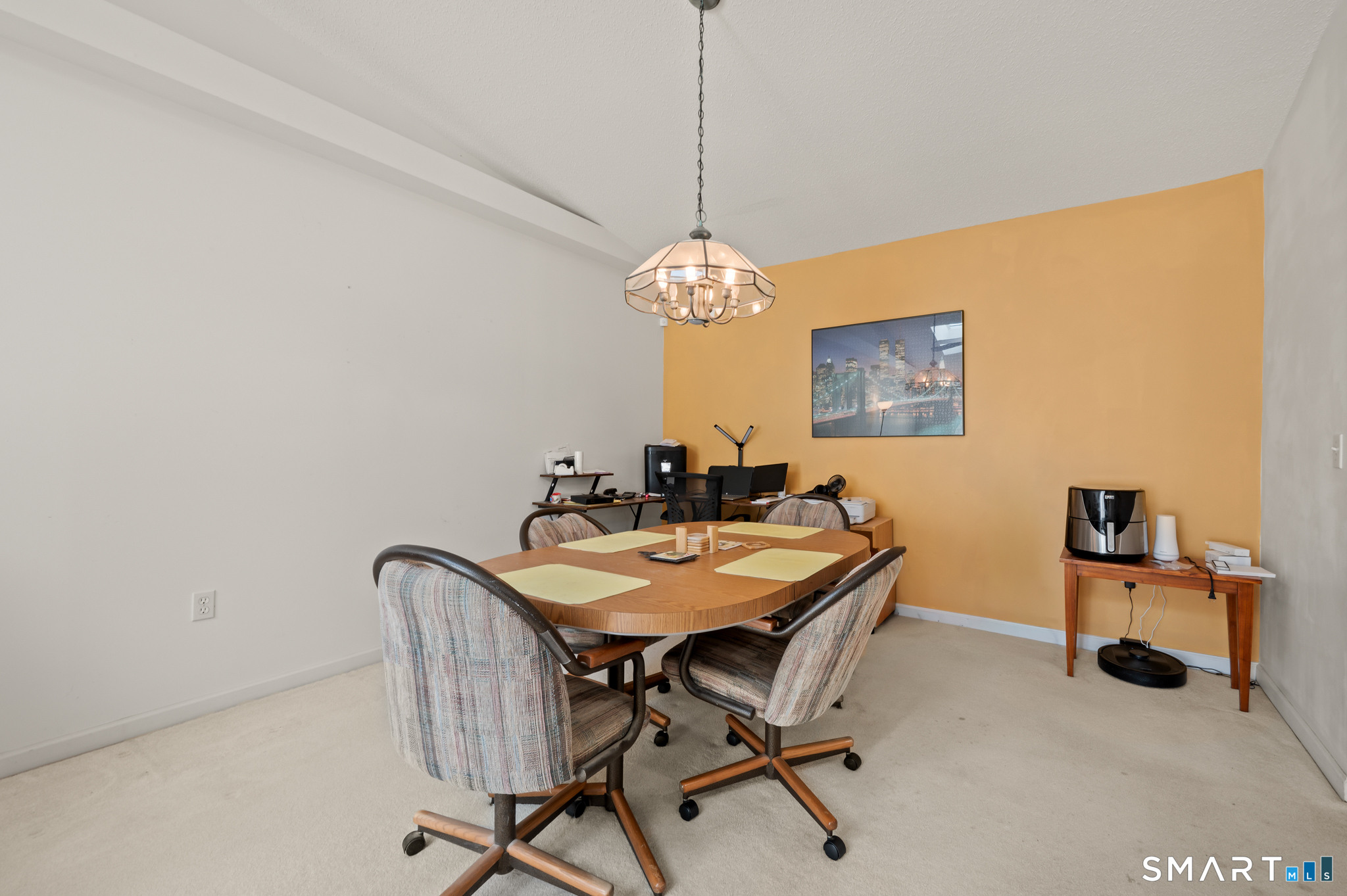 117 Dibble Hollow Lane, Unit 117 Windsor Locks, CT 06096 - Photo 8 of 34 a view of a dining room with a table and chairs