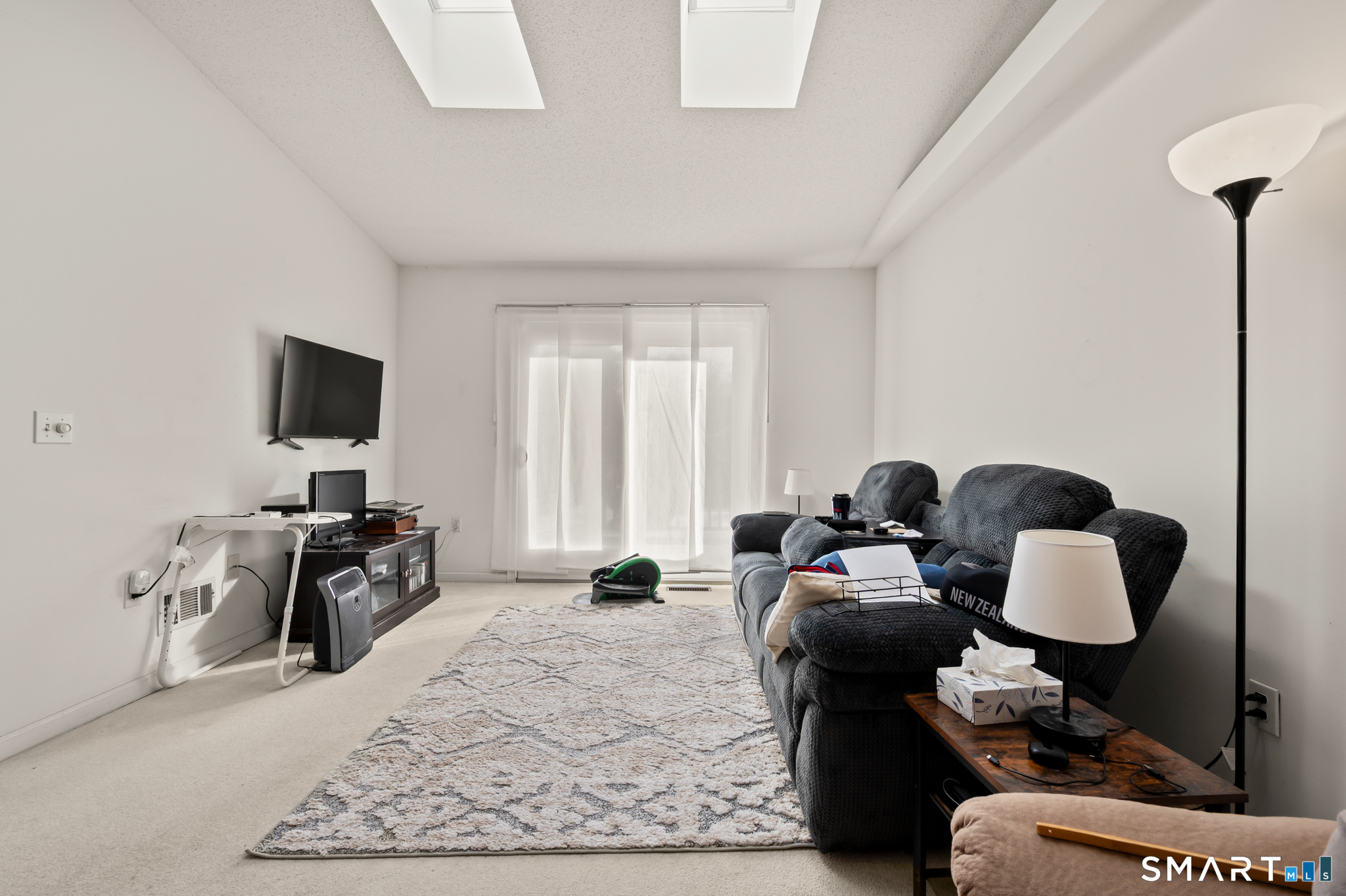 117 Dibble Hollow Lane, Unit 117 Windsor Locks, CT 06096 - Photo 10 of 34 a living room with furniture and a flat screen tv
