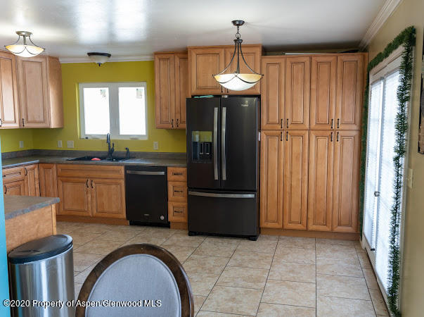 780 Cedar Court Rifle, CO 81650 - Photo 23 of 31 a kitchen with stainless steel appliances granite countertop a refrigerator and a sink