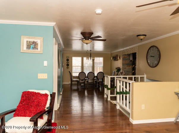 780 Cedar Court Rifle, CO 81650 - Photo 5 of 31 a living room with furniture a window and a chandelier