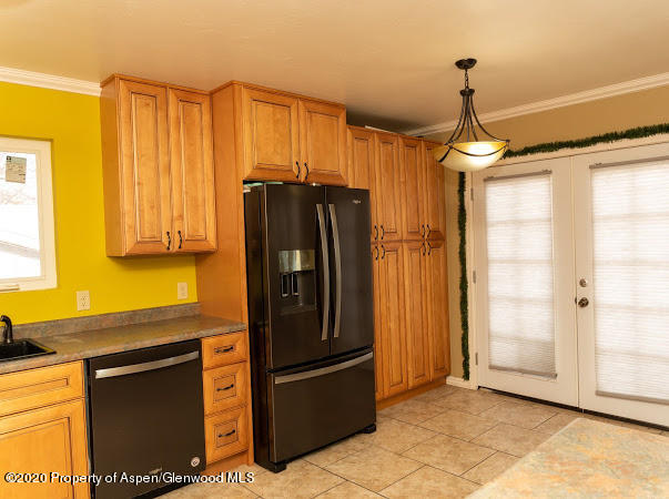 780 Cedar Court Rifle, CO 81650 - Photo 6 of 31 a kitchen with stainless steel appliances granite countertop a refrigerator and a sink