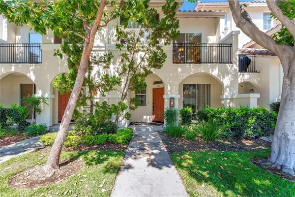 an aerial view of a house with a yard and trees
