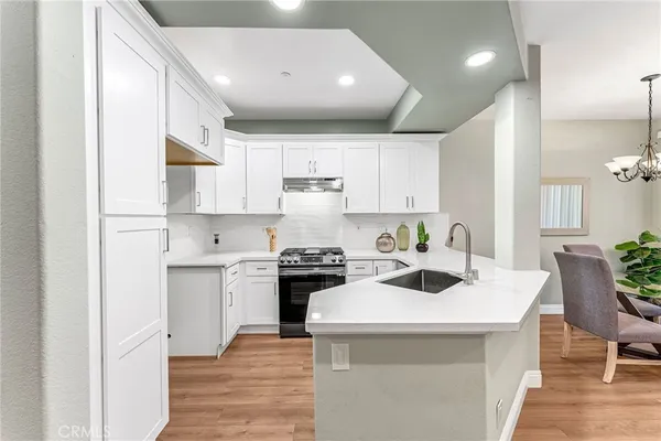 a kitchen with a sink a stove and cabinets