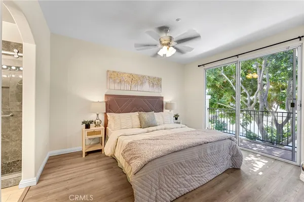 a bedroom with a large bed and a large window