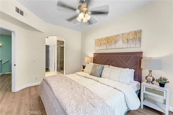 a bedroom with a bed and a chandelier