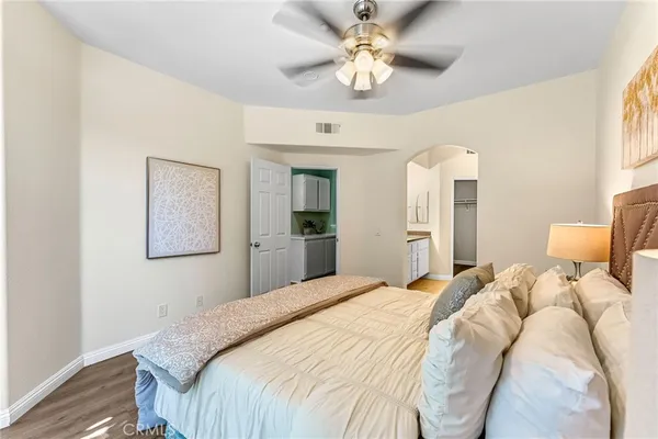 a bedroom with a large bed and a chandelier