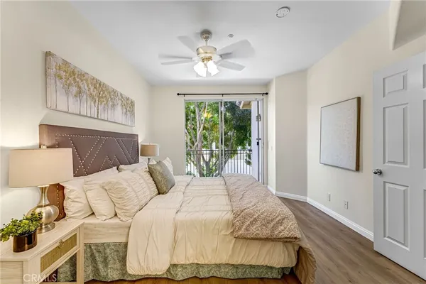 a bedroom with a large bed and a window