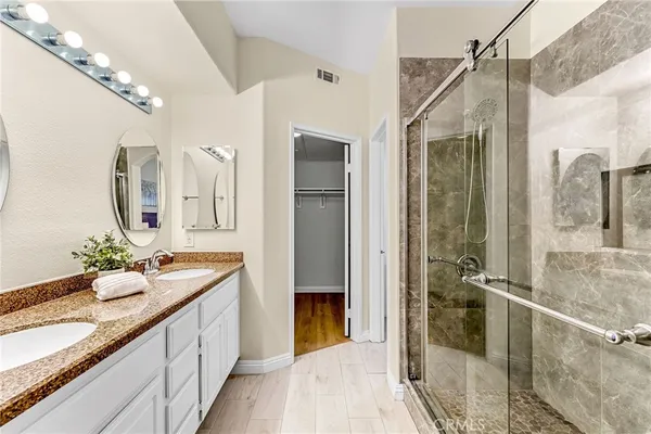 a spacious bathroom with a granite countertop sink mirror and vanity