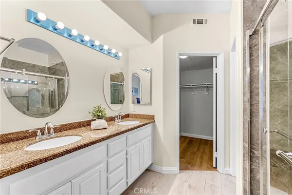 a bathroom with a double vanity sink and a mirror