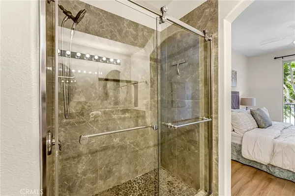 a bathroom with a shower and a glass door