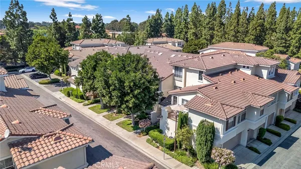 an aerial view of a house with a yard and trees