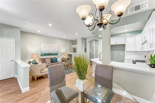 a living room with kitchen island furniture and a chandelier