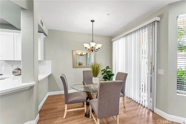 a dining room with furniture window and wooden floor