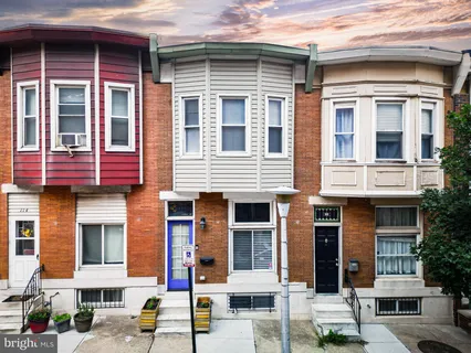 a front view of a residential apartment building with a yard