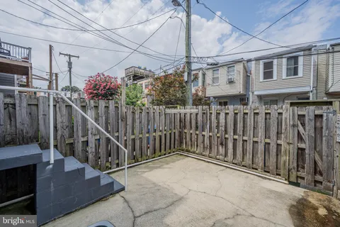 a view of a house with a wooden fence