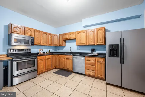 a kitchen with stainless steel appliances granite countertop a sink and cabinets