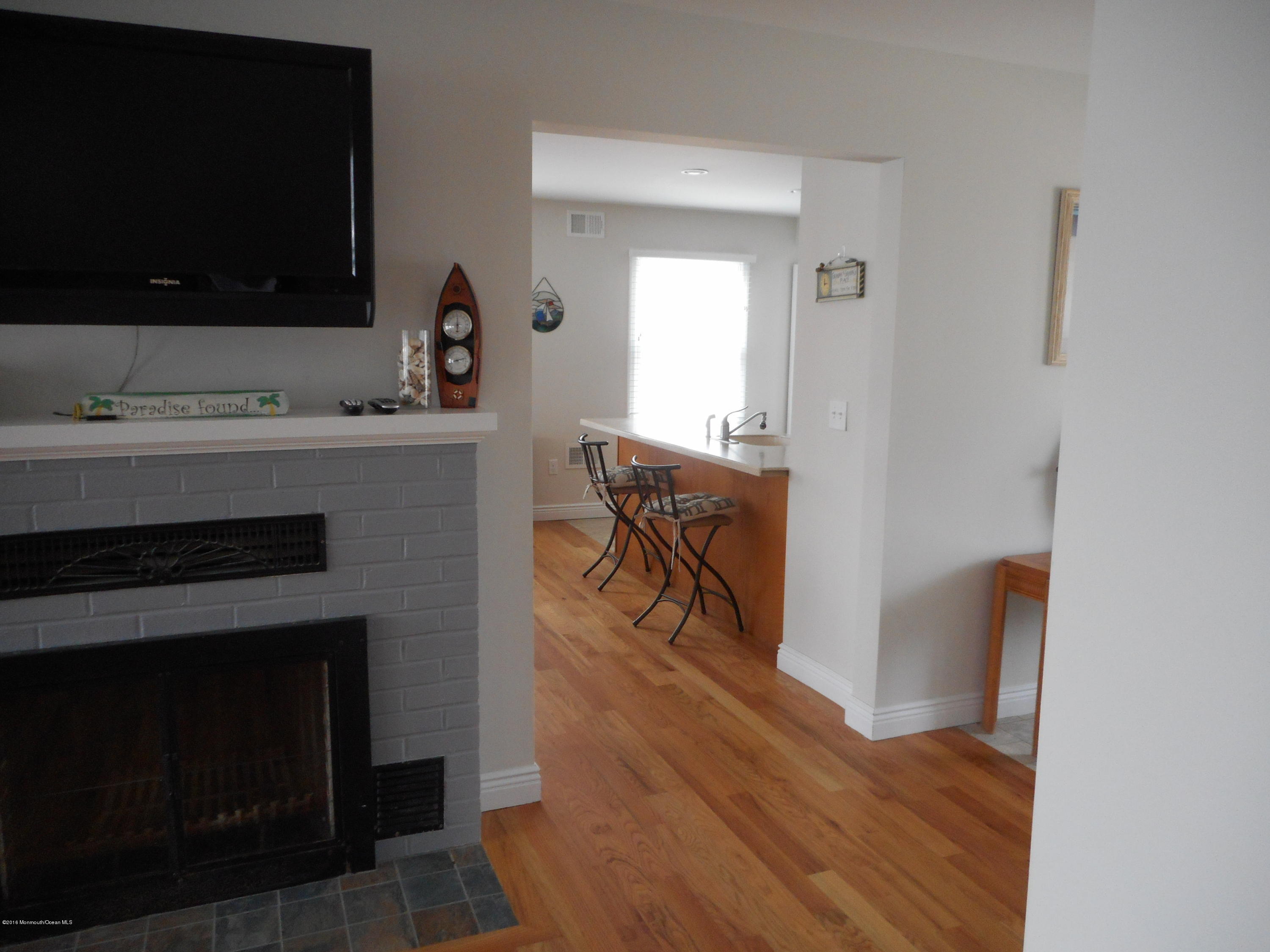 712 Drum Point Road Brick, NJ 08723 - Photo 12 of 23 a living room with furniture and a flat screen tv
