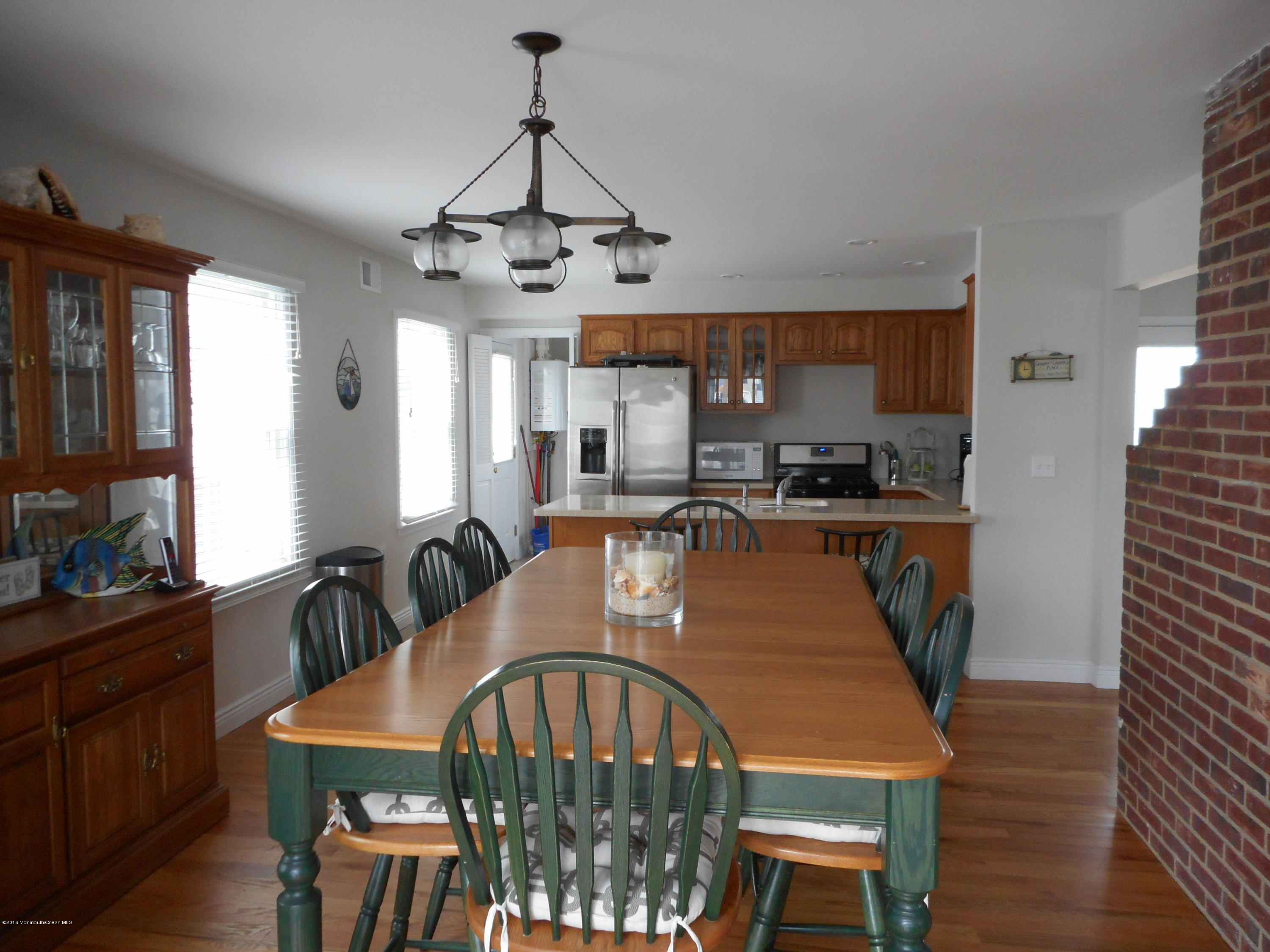 712 Drum Point Road Brick, NJ 08723 - Photo 13 of 23 a view of a a dining room with furniture window and wooden floor