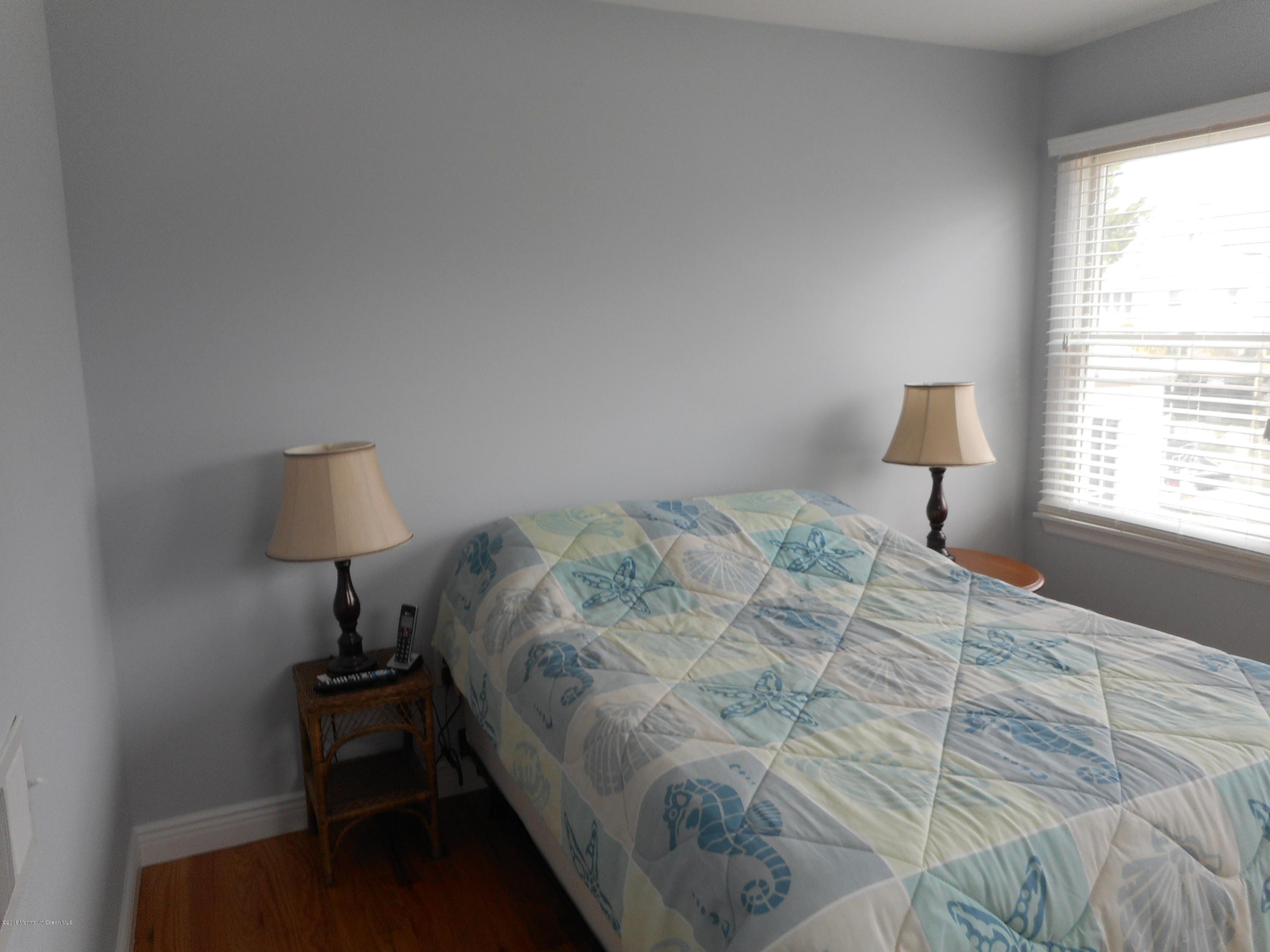712 Drum Point Road Brick, NJ 08723 - Photo 16 of 23 a bedroom with a bed window and a table in it