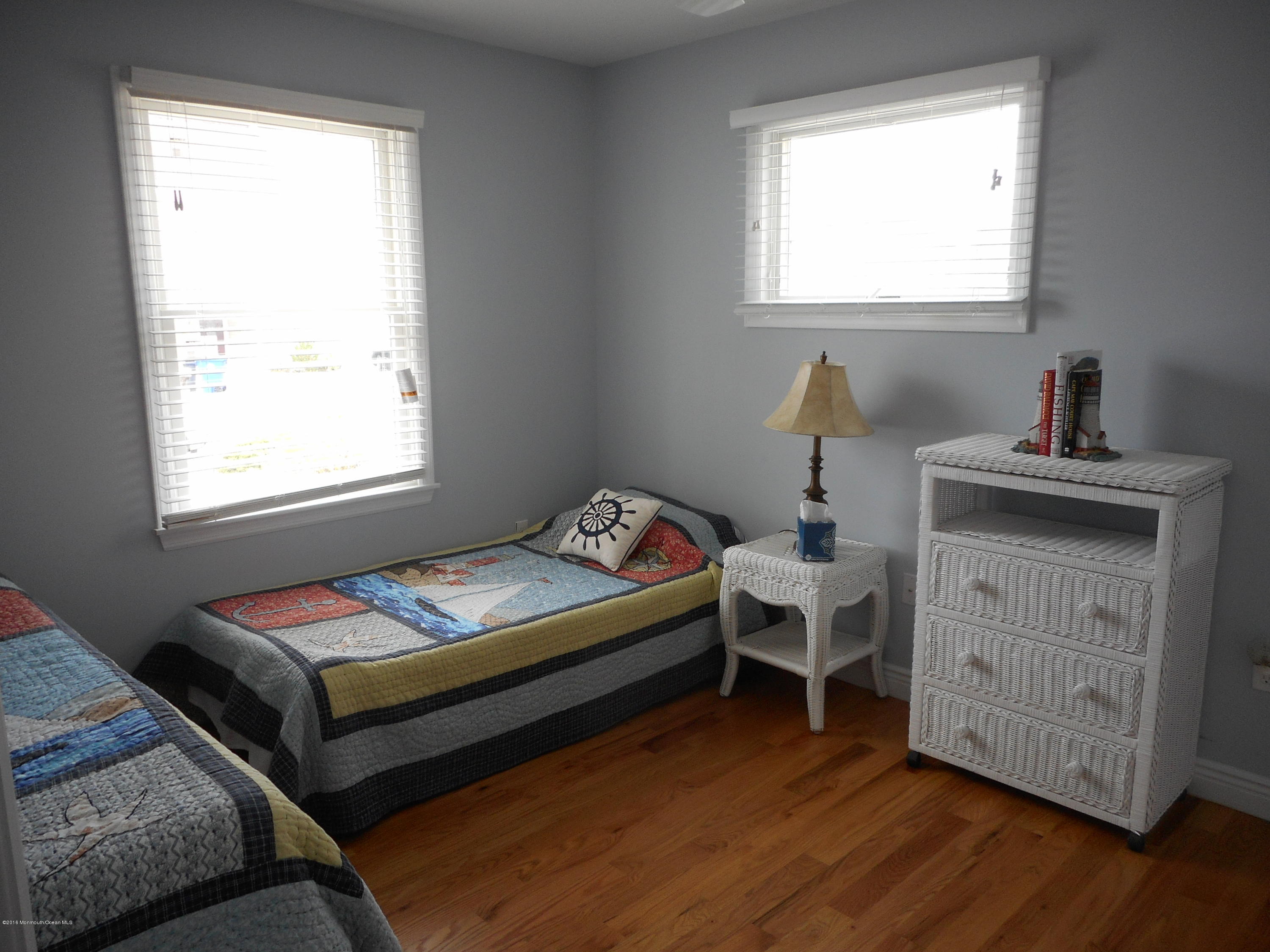 712 Drum Point Road Brick, NJ 08723 - Photo 17 of 23 a bedroom with a bed and a desk