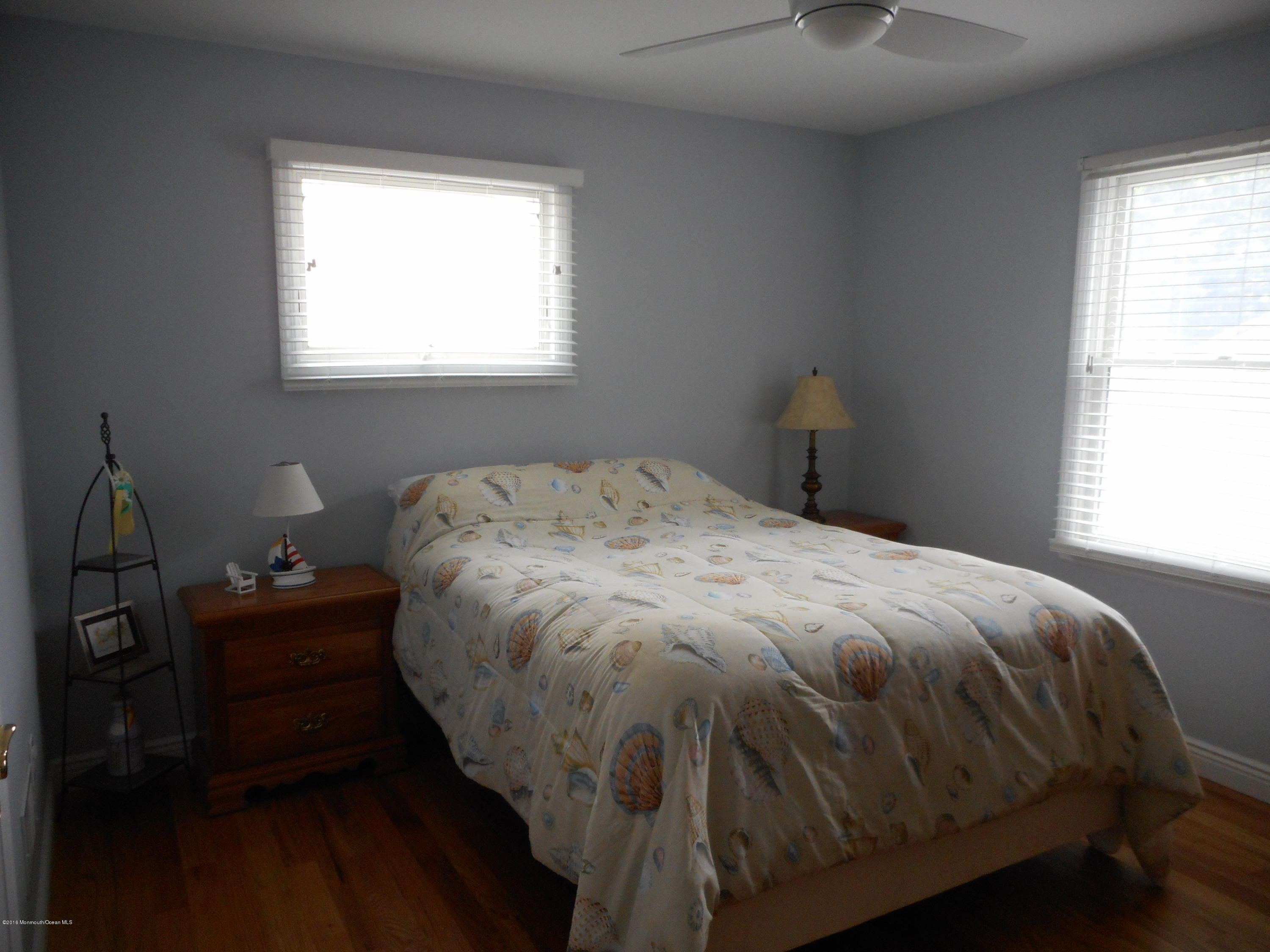 712 Drum Point Road Brick, NJ 08723 - Photo 18 of 23 a bed sitting in a bedroom next to a window