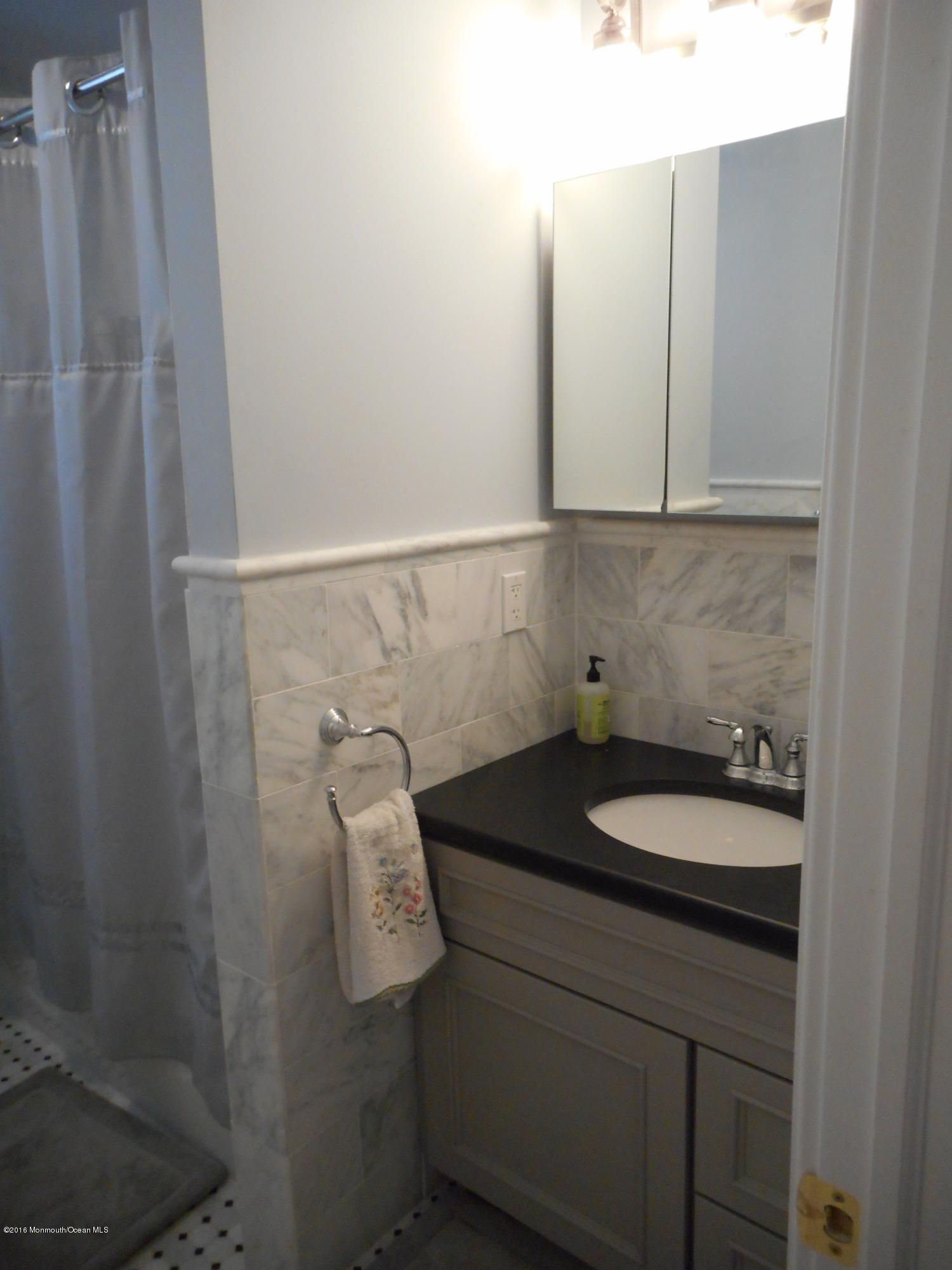 712 Drum Point Road Brick, NJ 08723 - Photo 20 of 23 a bathroom with a granite countertop sink and a mirror