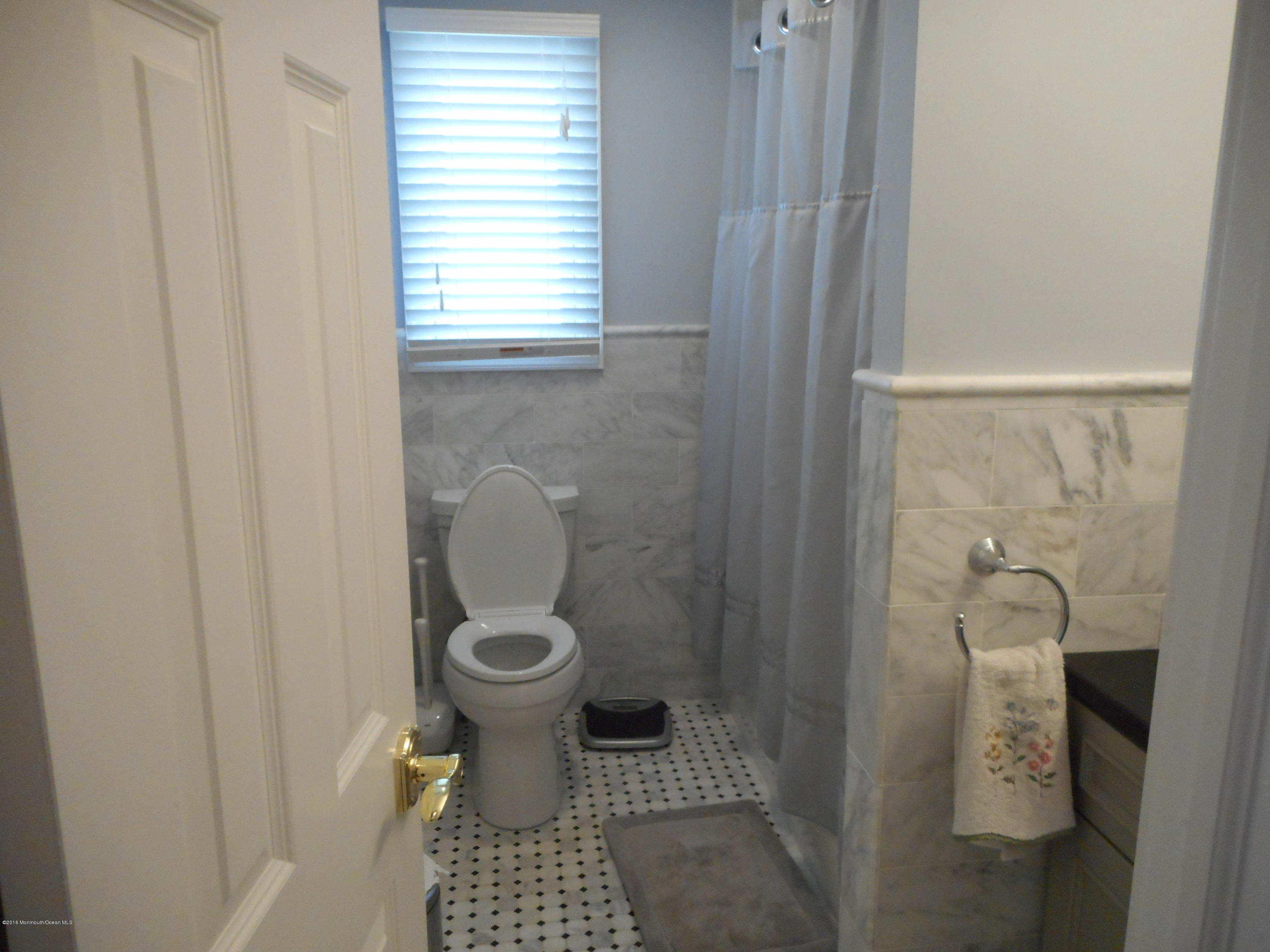 712 Drum Point Road Brick, NJ 08723 - Photo 21 of 23 a bathroom with a toilet and a shower