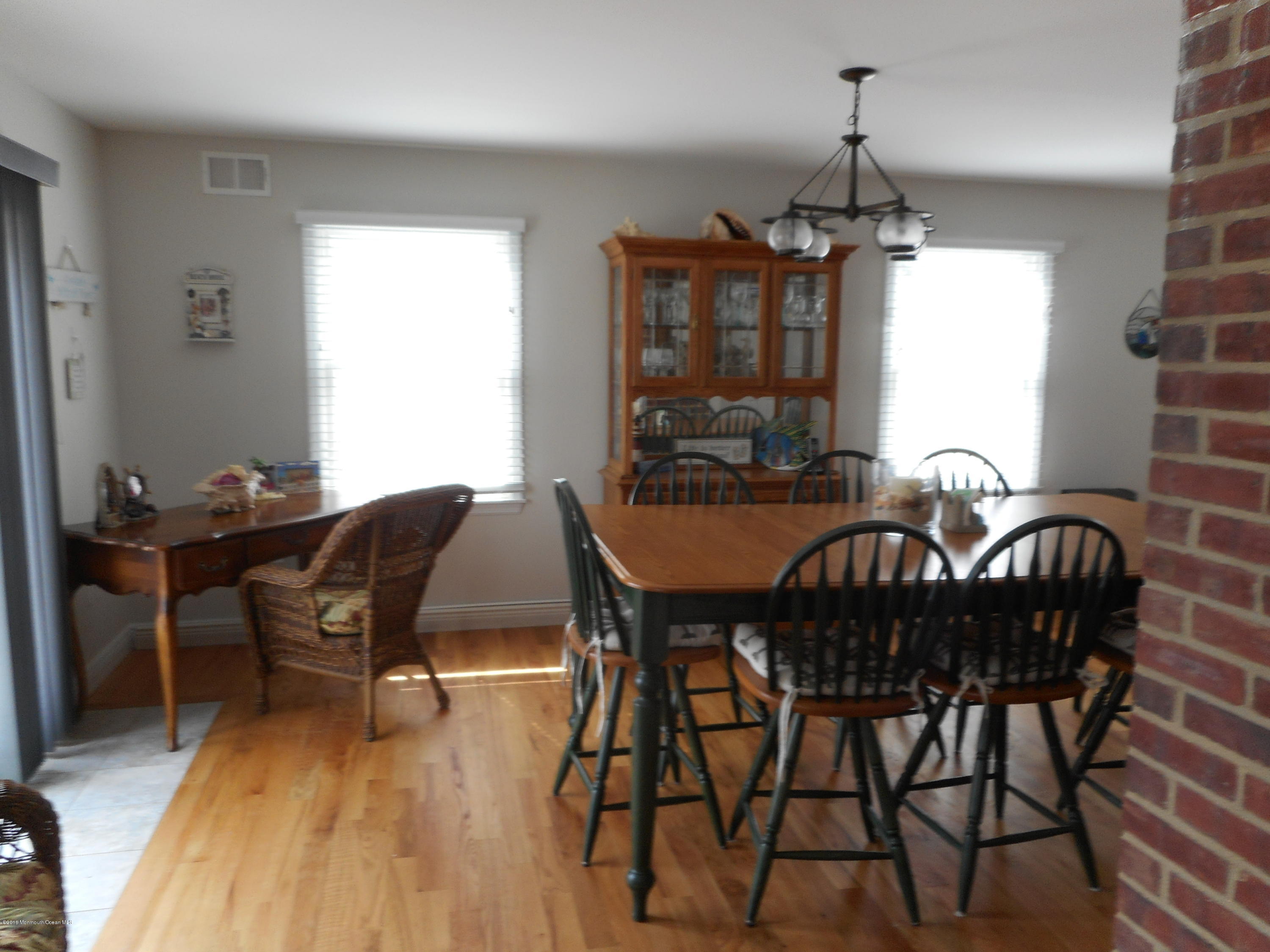 712 Drum Point Road Brick, NJ 08723 - Photo 10 of 23 a view of a dining room with furniture window and wooden floor