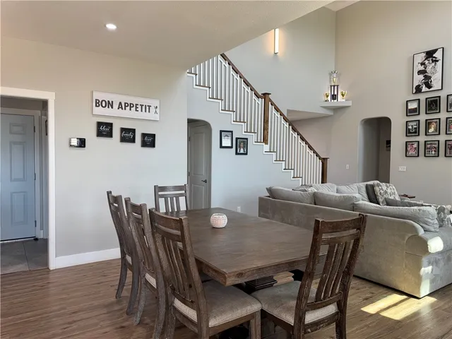 a kitchen with stainless steel appliances granite countertop a sink a stove and a wooden floors