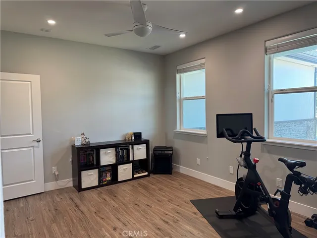 a bathroom with a granite countertop sink toilet and mirror