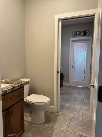 a kitchen with granite countertop a stove sink and cabinets