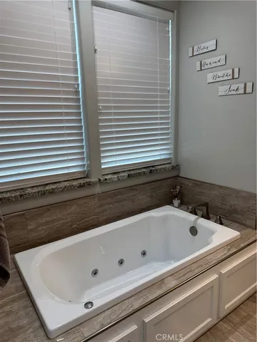 a bedroom with a bed dresser and window