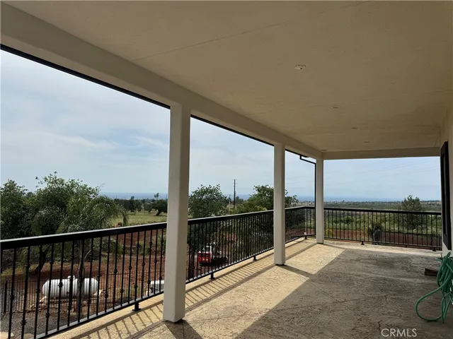 a view of a garden with cars park