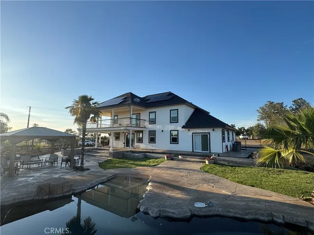 a front view of a house with yard and green space