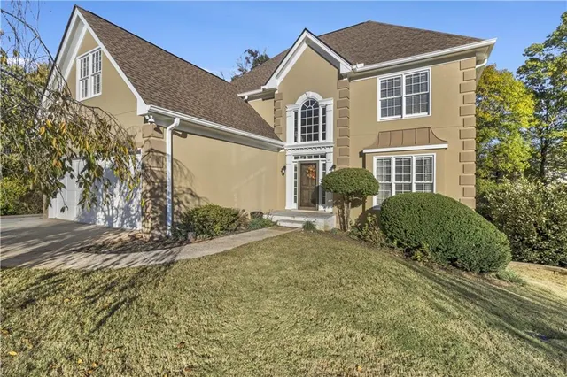 a front view of a house with a yard