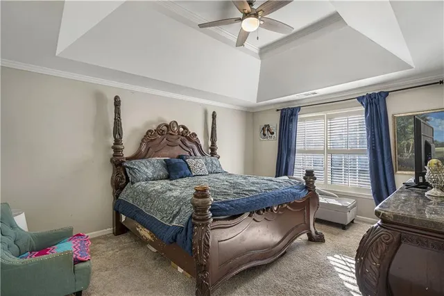 a bedroom with a bed and a television