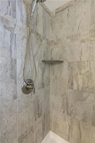 a bedroom with a bed couch and window