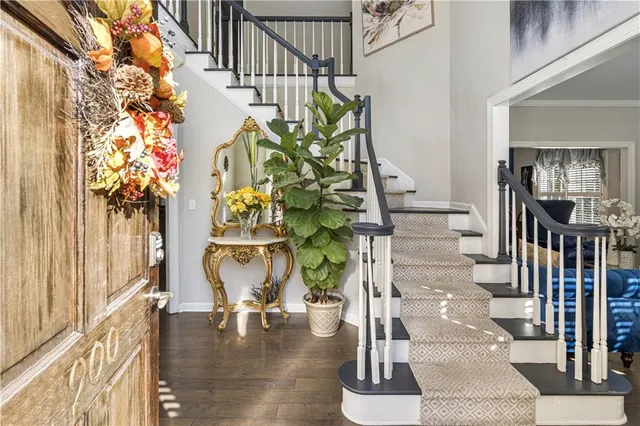 a vase of flowers sitting on a floor in front of a window