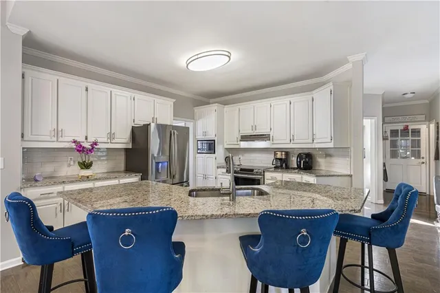a living room with furniture a fireplace and a large window