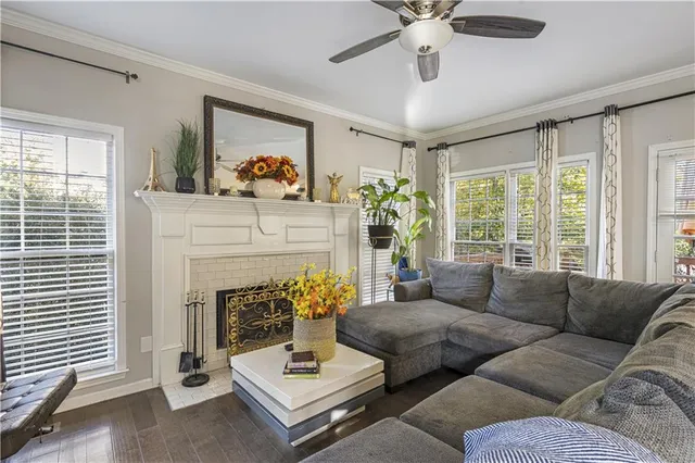 a living room with furniture a fireplace and a flat screen tv