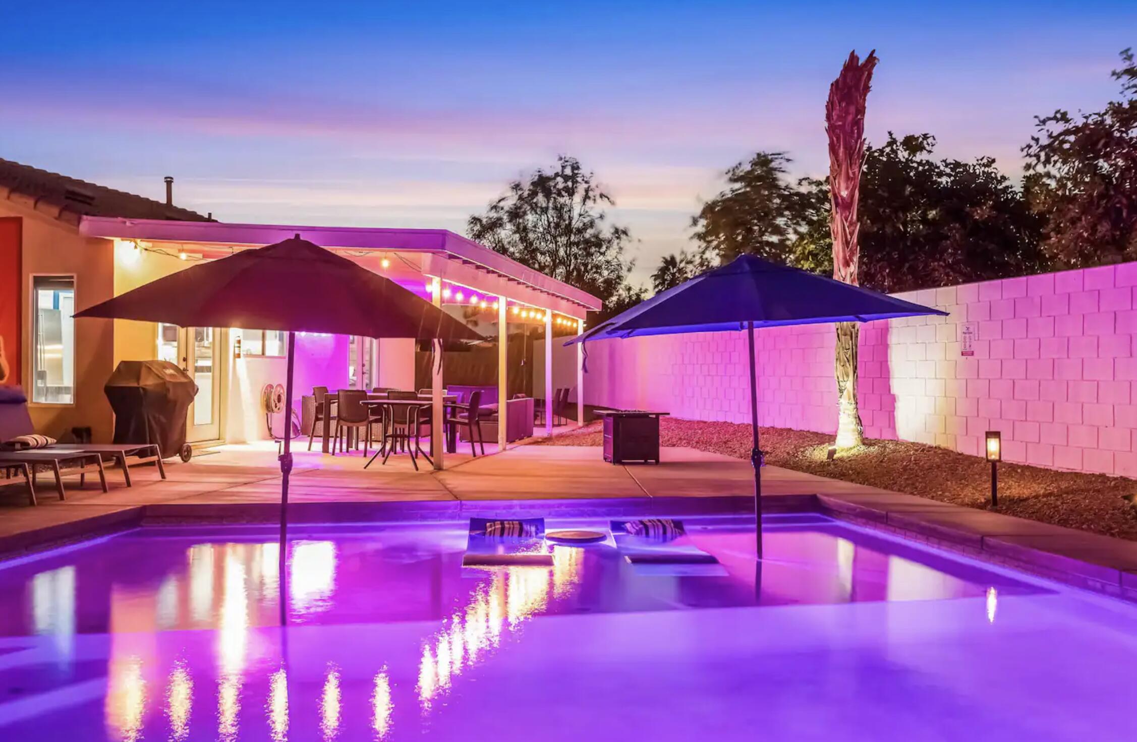 a view of a patio with a table and chairs under an umbrella